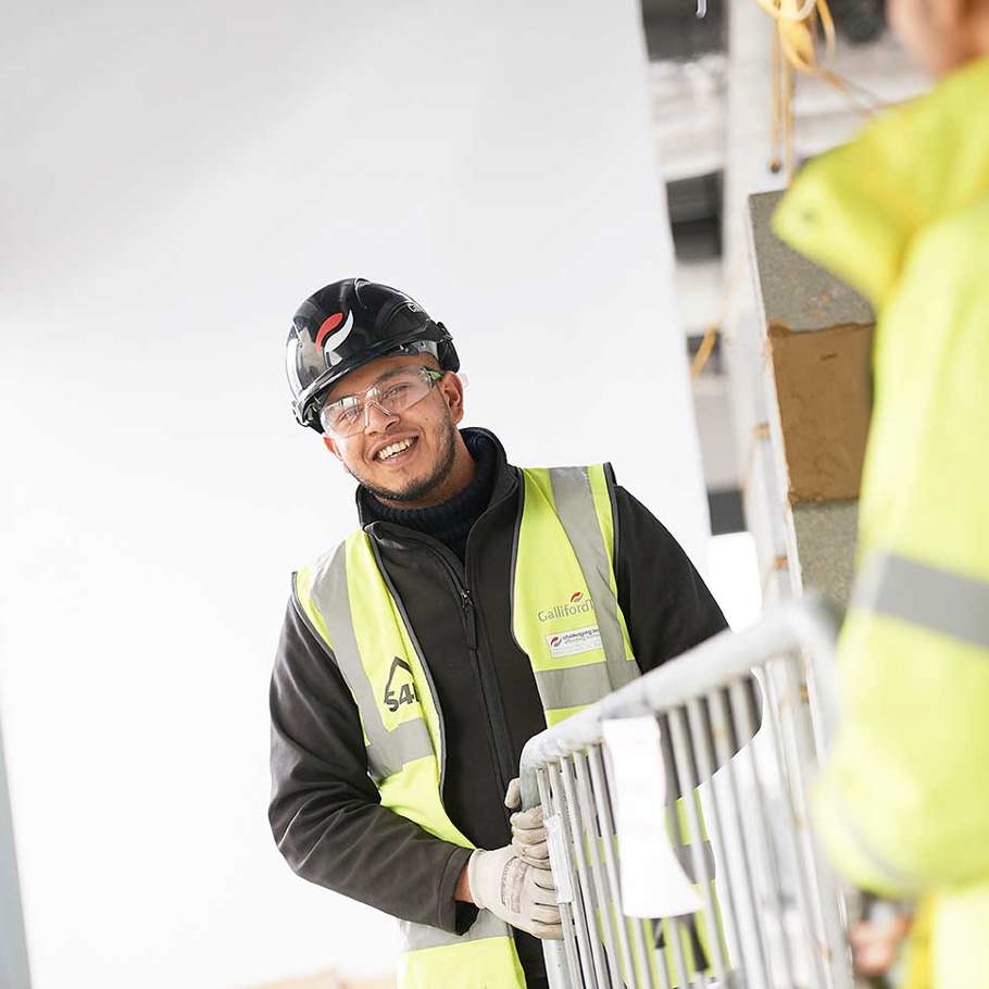 2 people on site moving a railing 