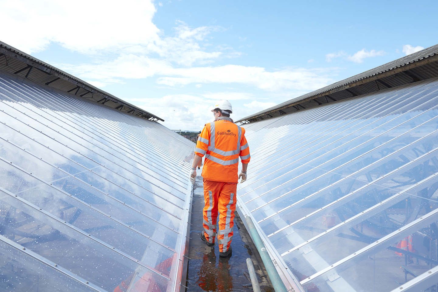 site person walking on a glass roof 