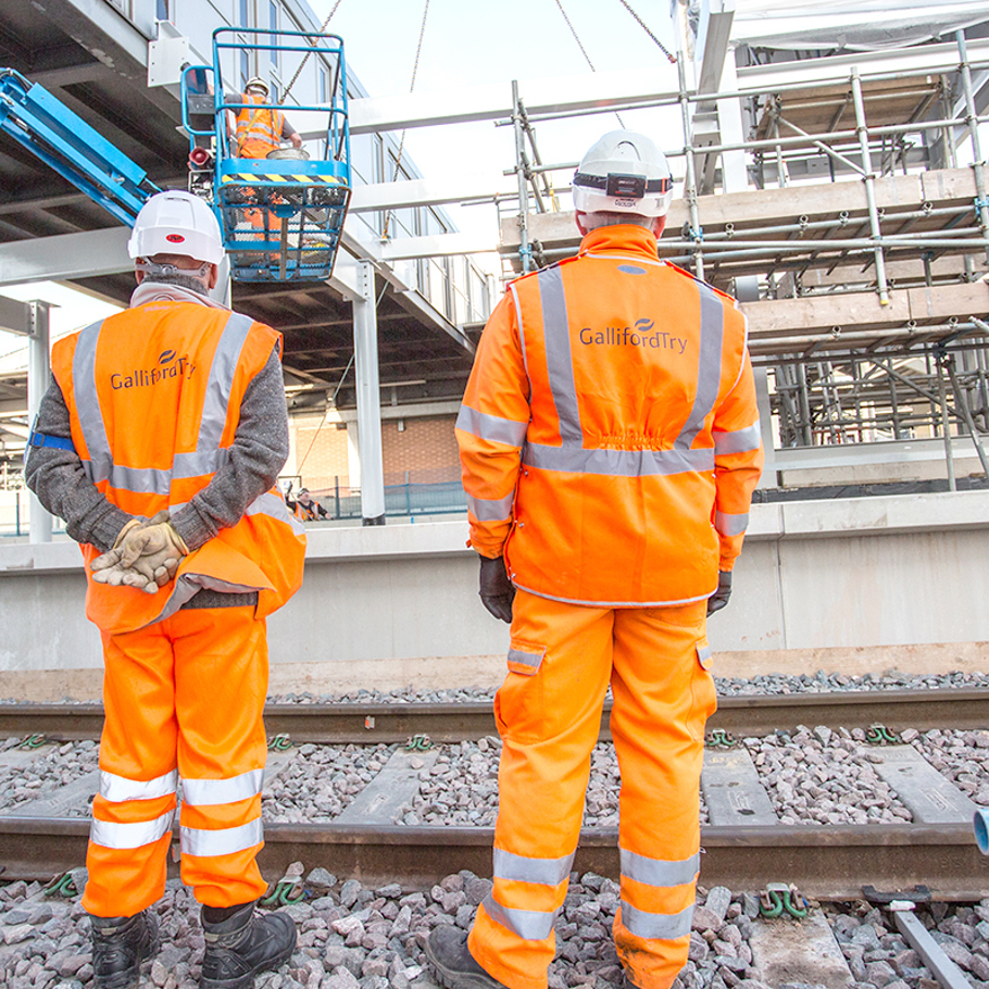 2 people in PPE on a railway 